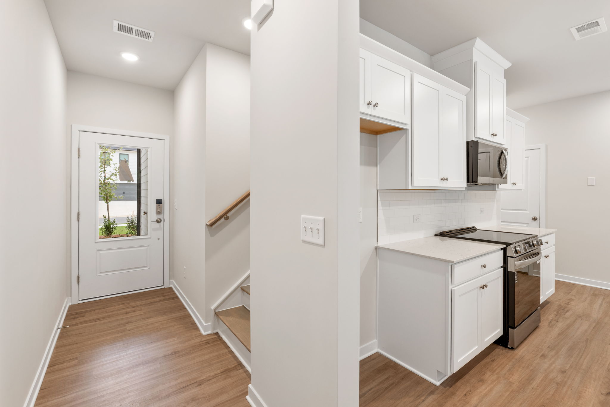 A kitchen with white cabinets.