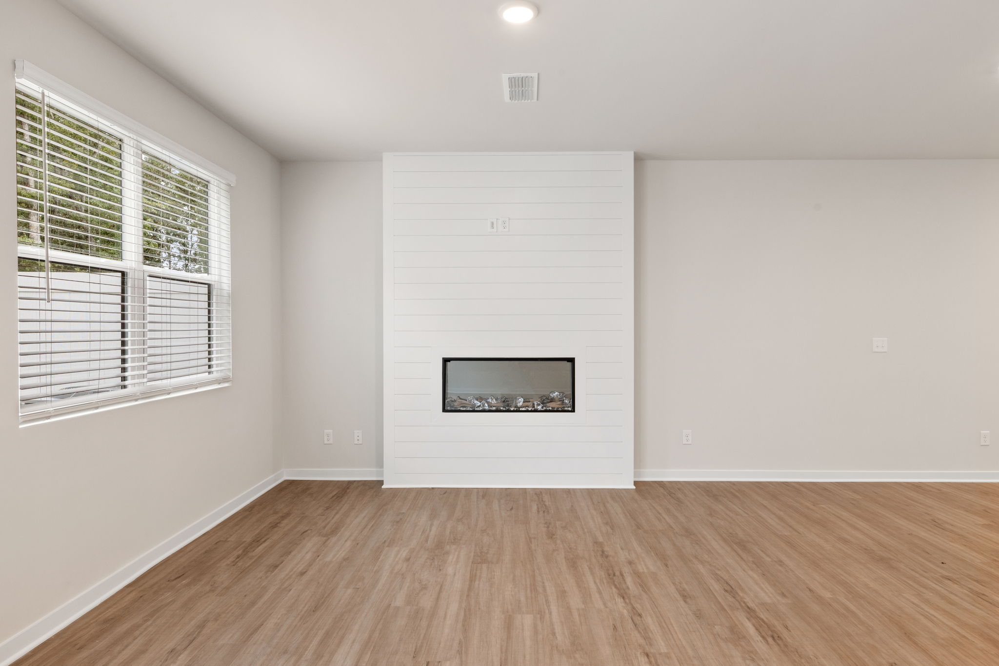 A room with a fireplace and a window.
