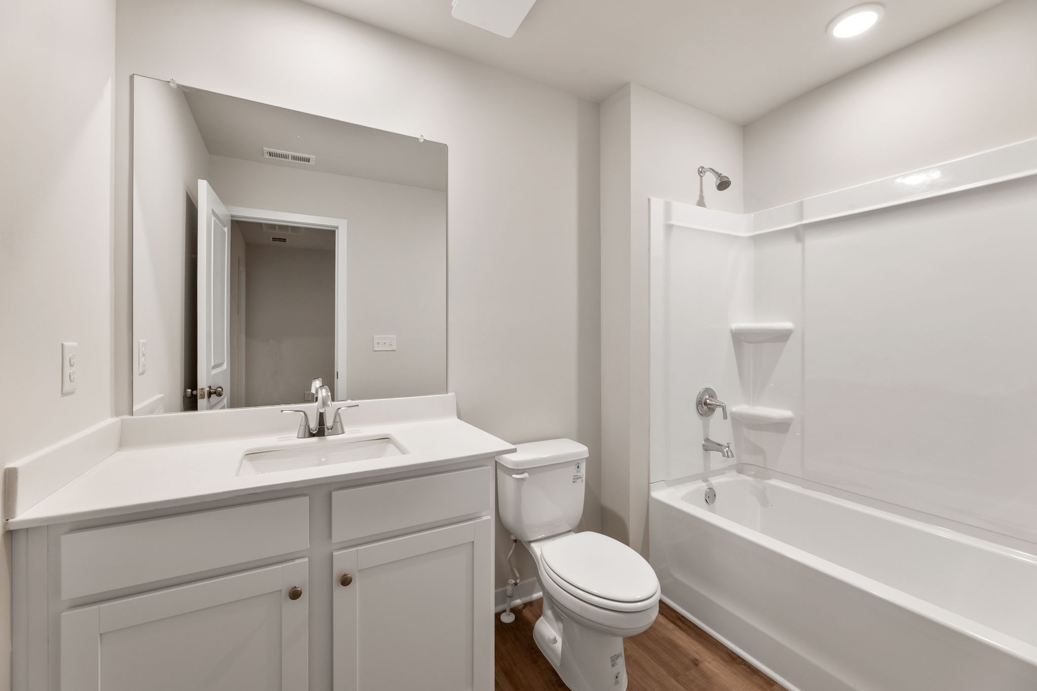 A bathroom with a tub toilet and sink.
