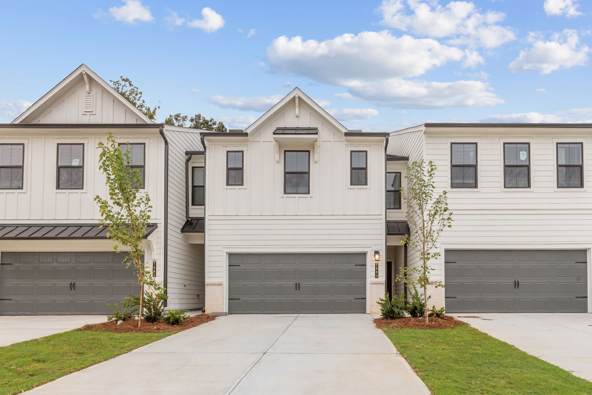 A white building with a garage.