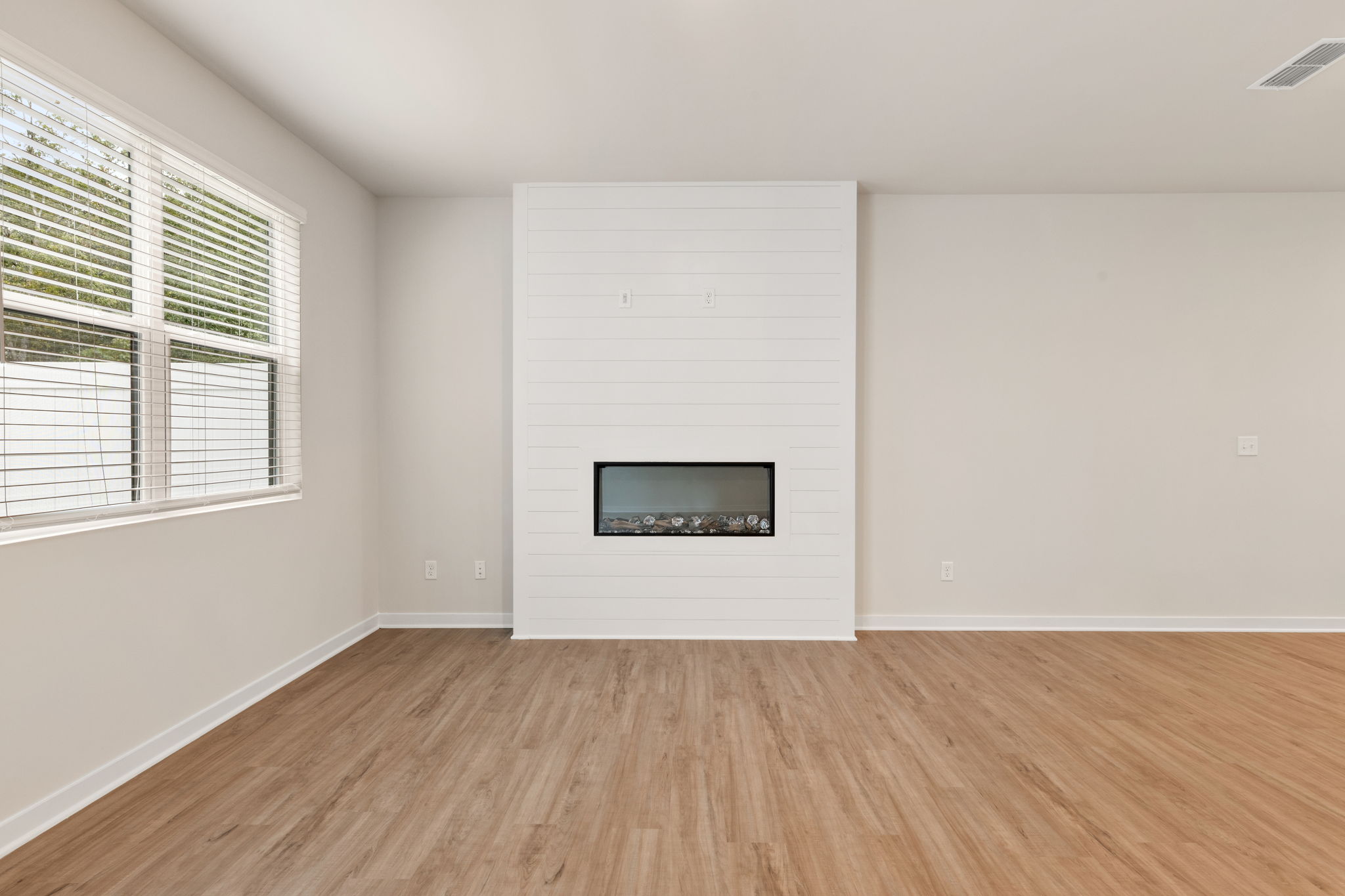 A room with a tv and a window.