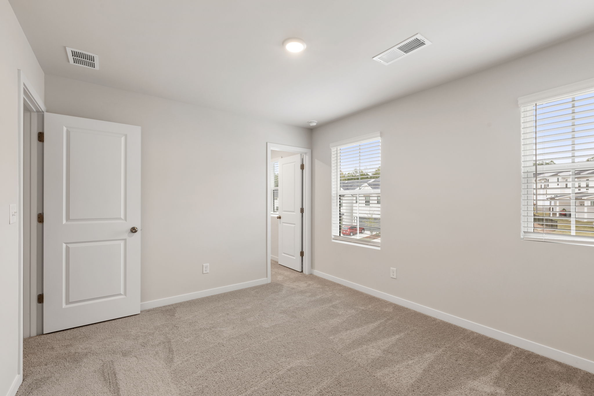 A room with white walls and a carpeted floor.