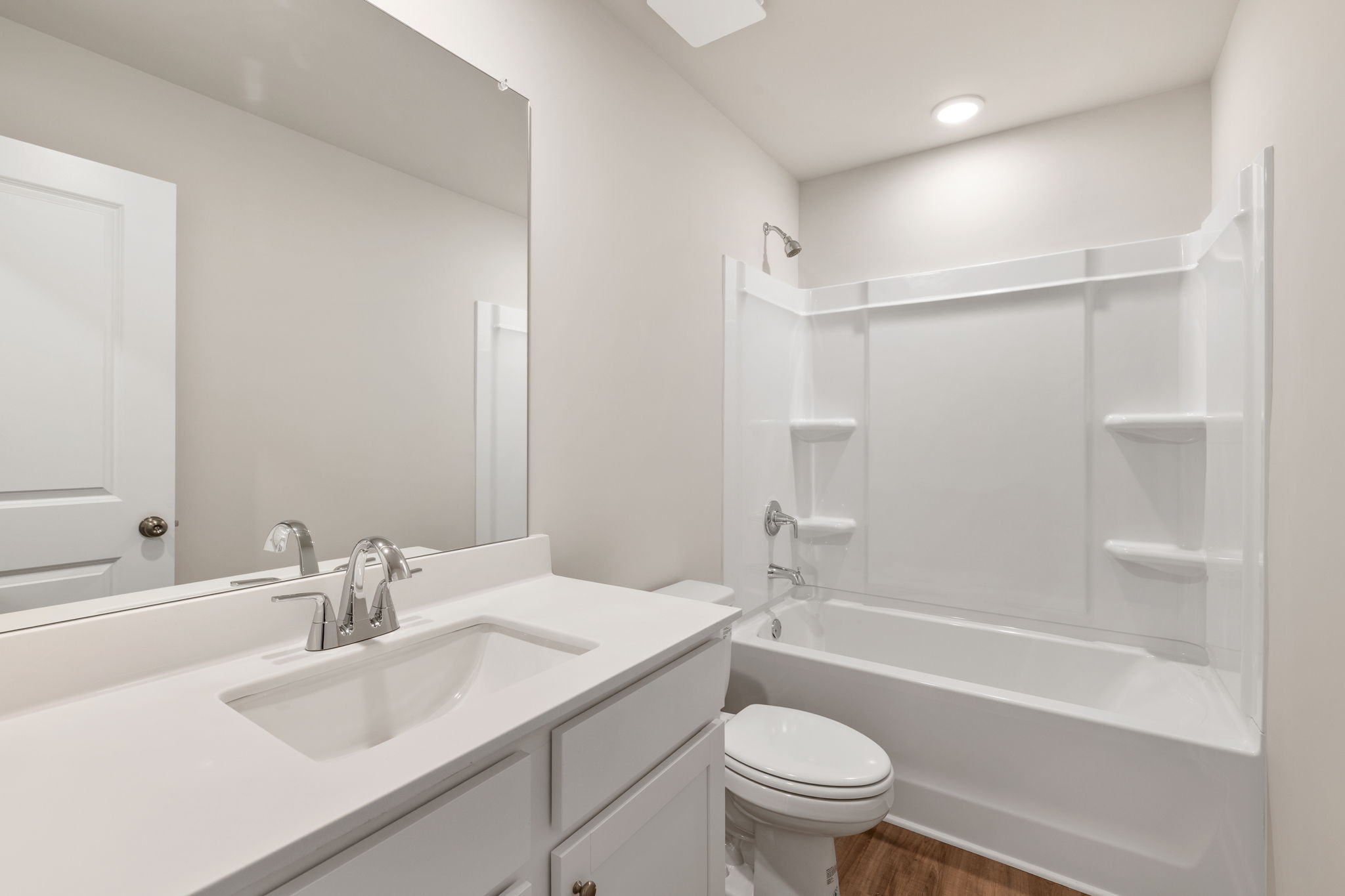 A bathroom with a sink toilet and bathtub.