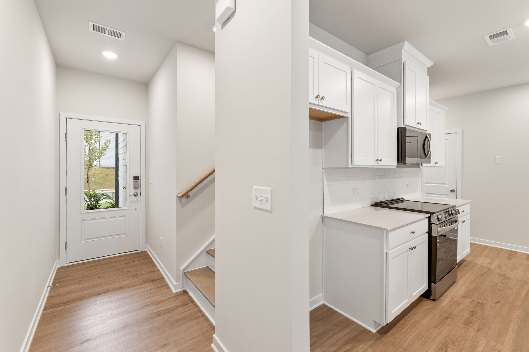 A kitchen with white cabinets.