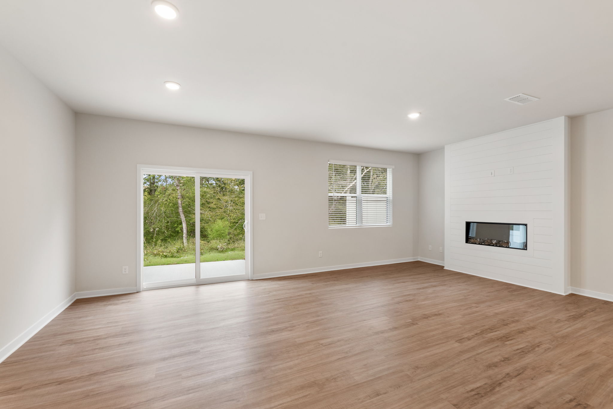 A room with a wood floor and a wood floor.