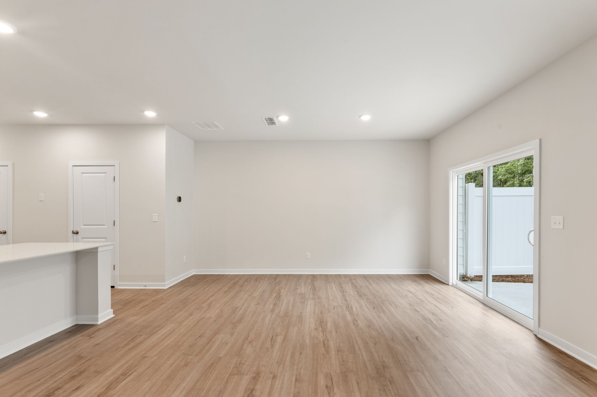A room with white walls and a wood floor.