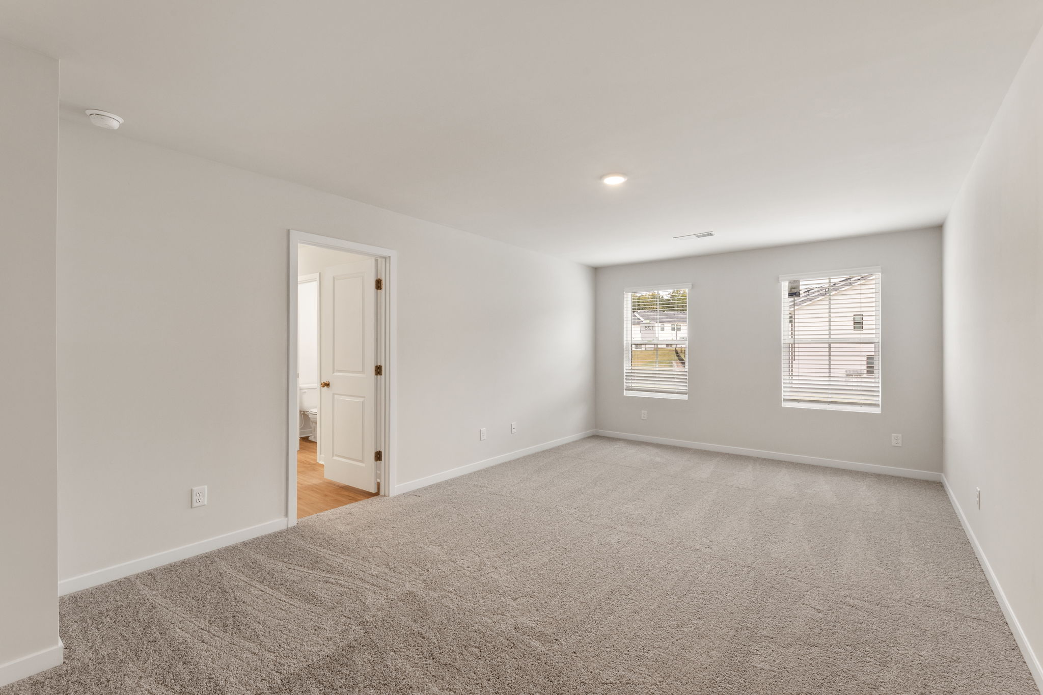A hallway with a door and a window.