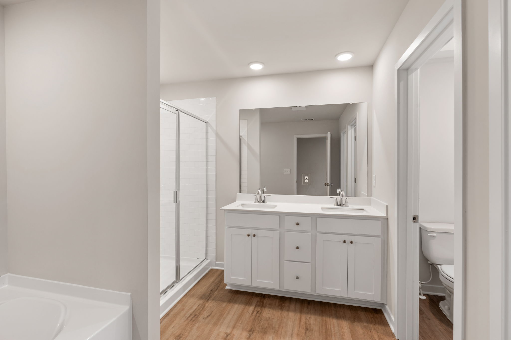 A bathroom with white cabinets.