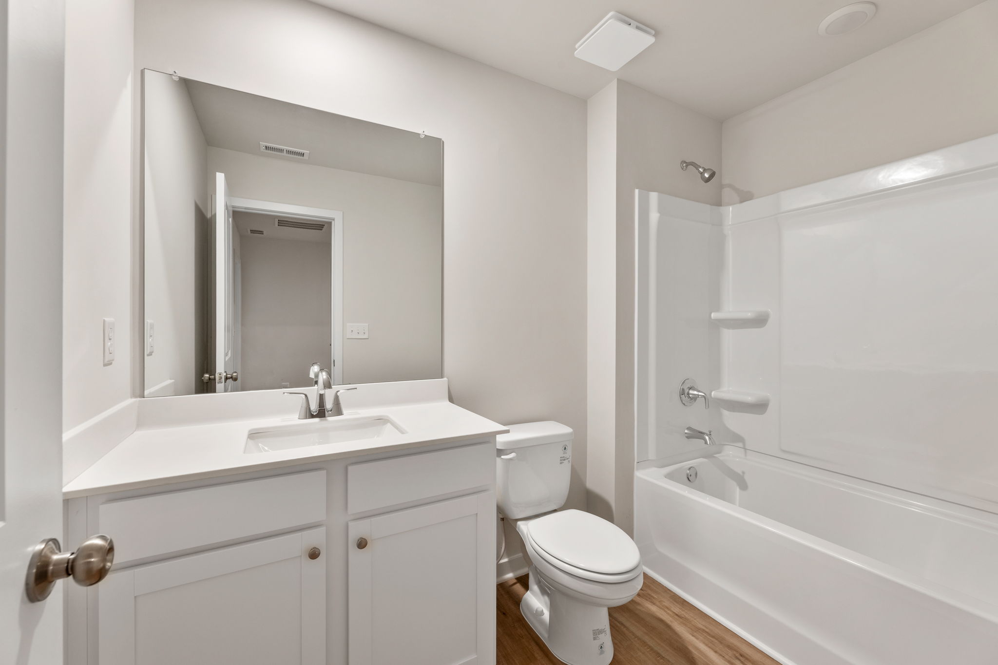 A bathroom with a tub sink and toilet.