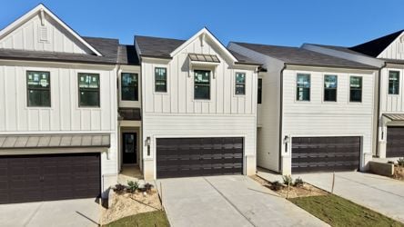 A white house with a garage.
