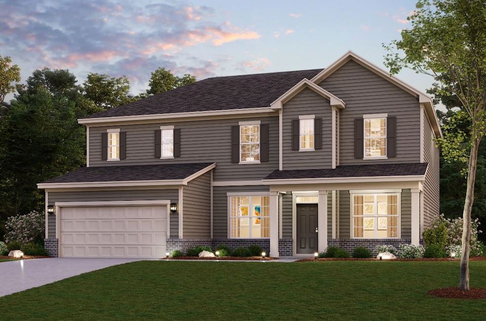 A house with a lawn in front of it.