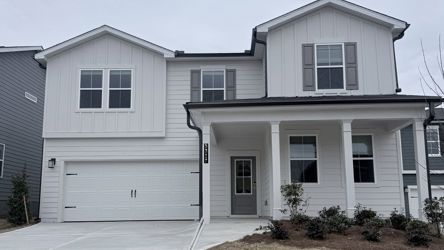 A white house with a garage.