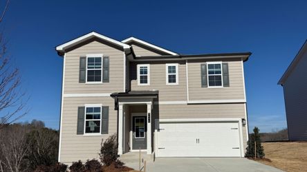 A white house with a garage.