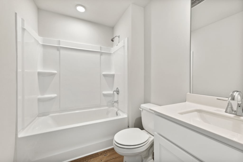 A bathroom with a tub toilet and sink.