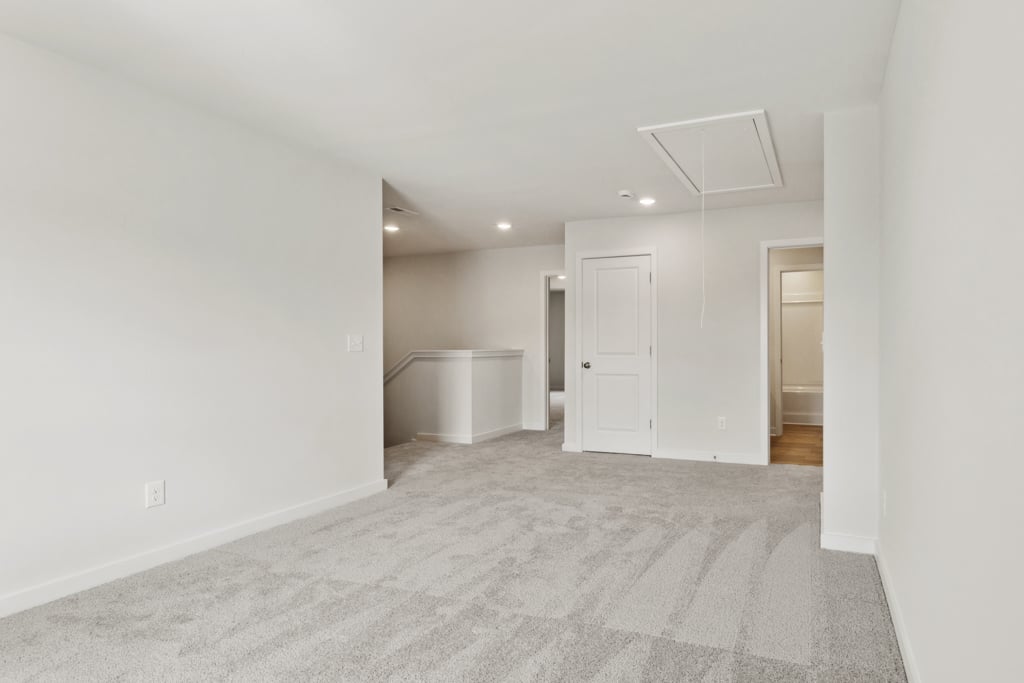 A hallway with white walls.