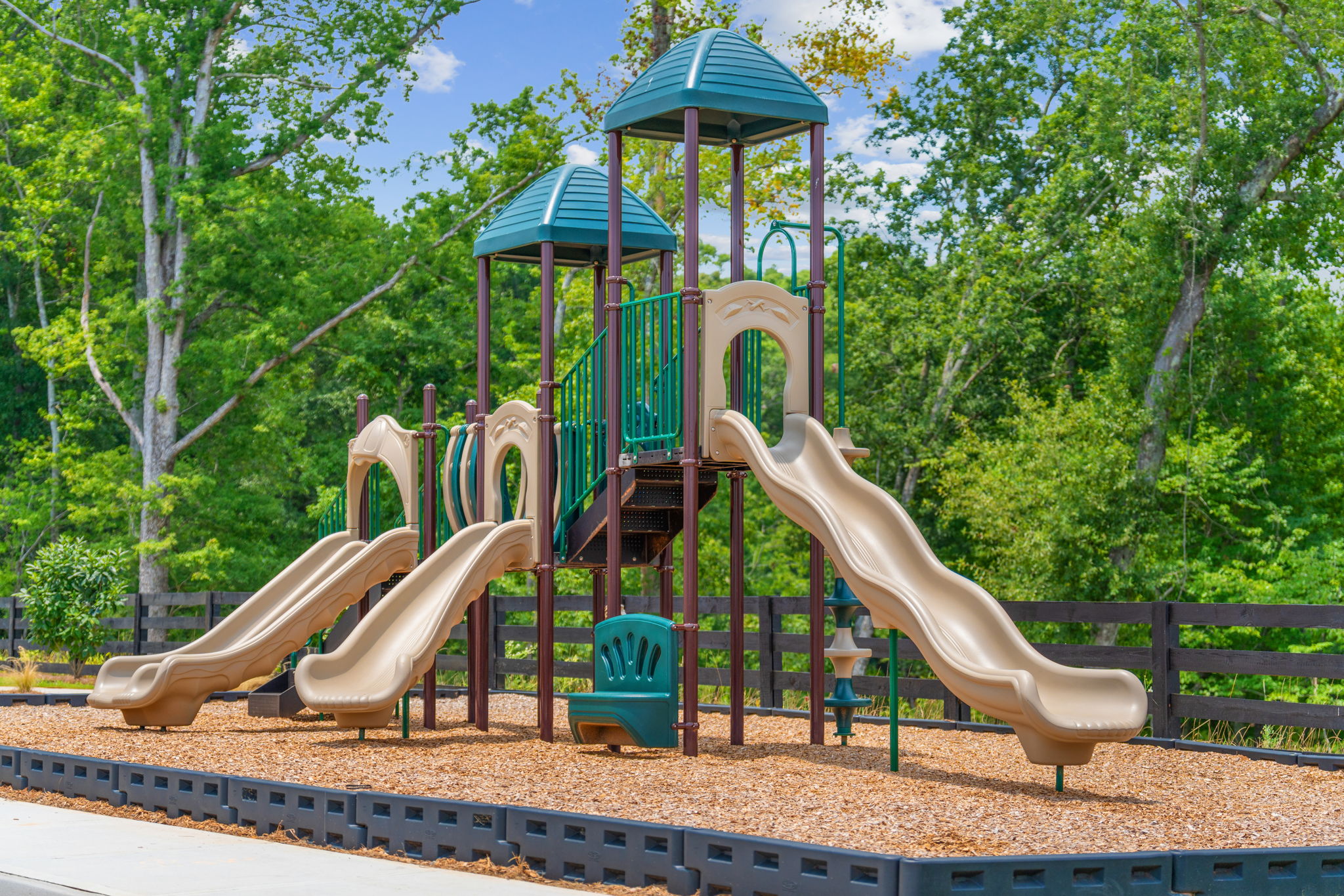 A children's playground with trees.
