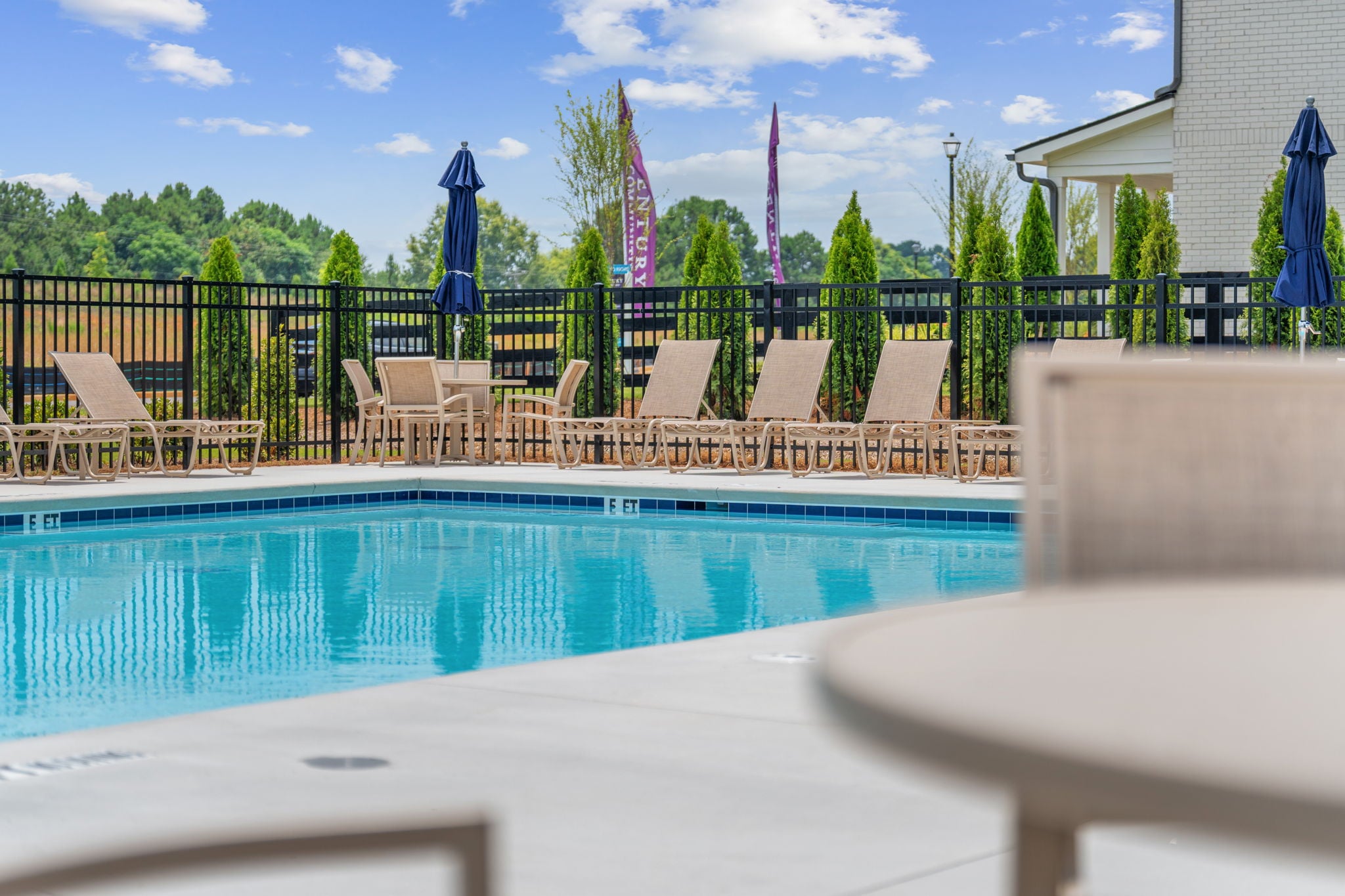 A pool with chairs around it.