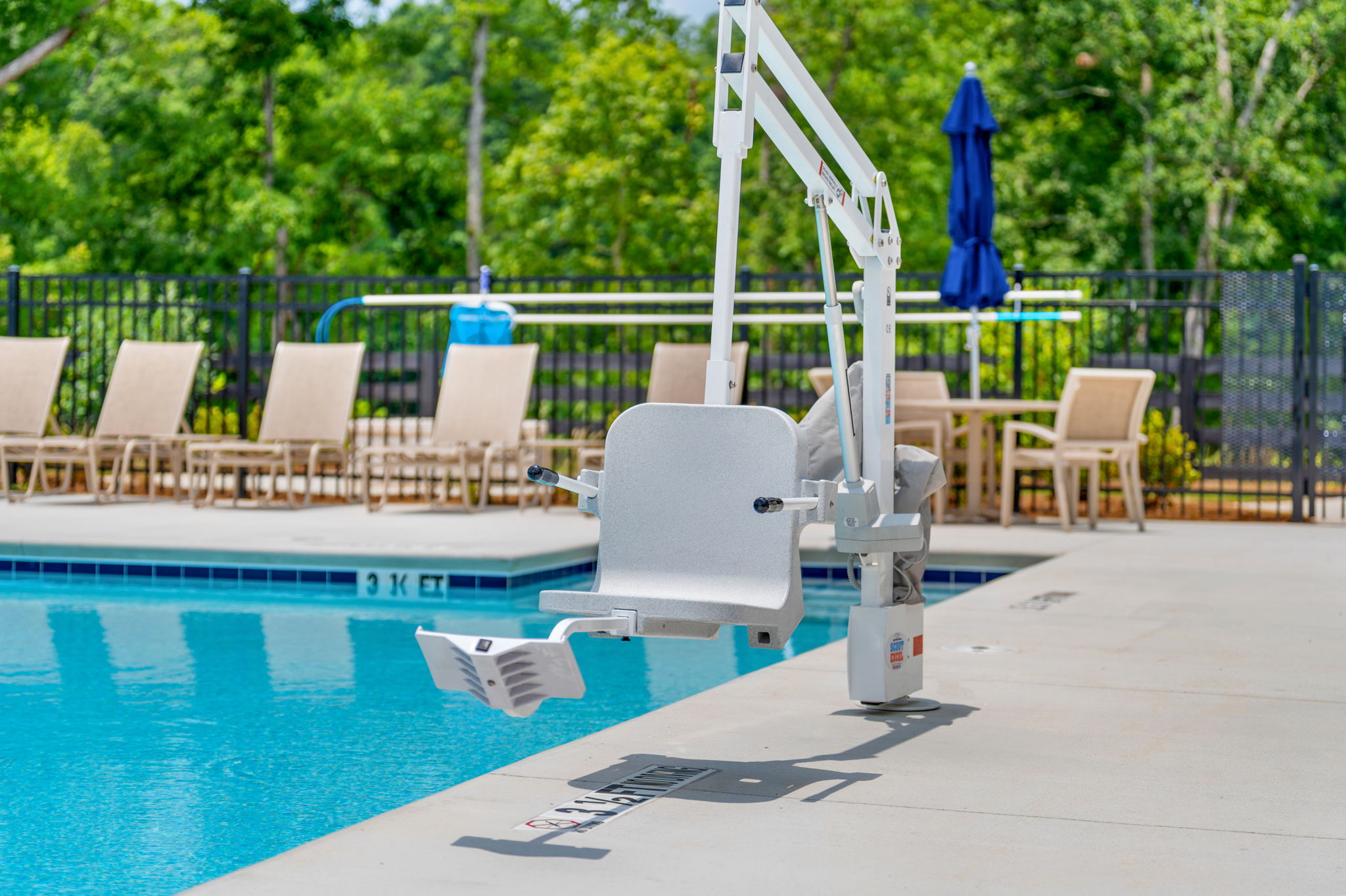 A pool with chairs around it.