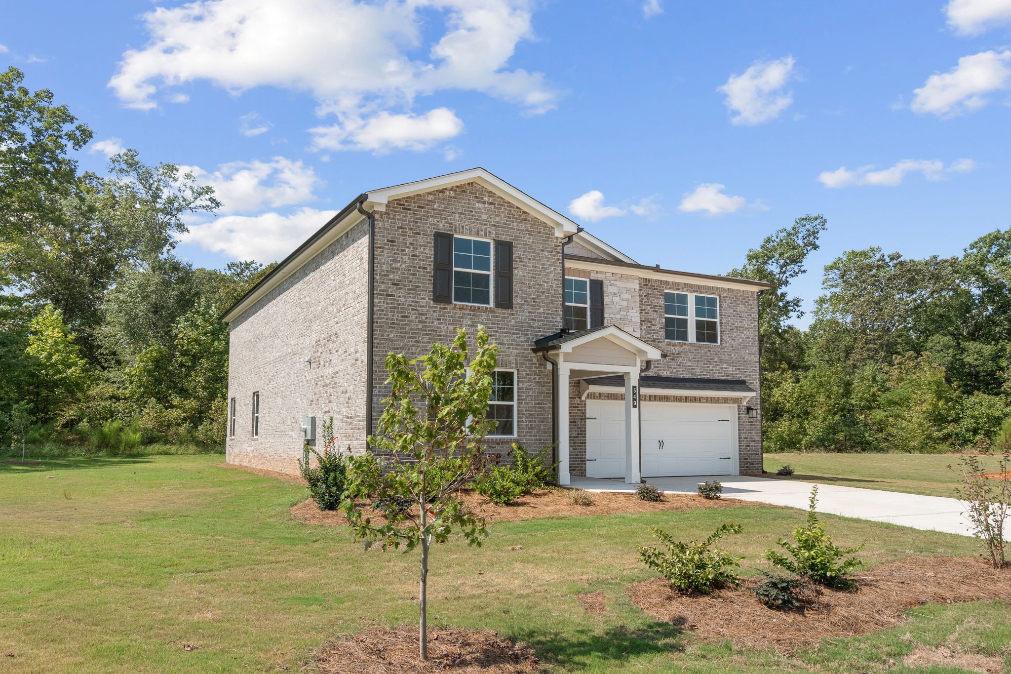 A house with garages and trees.