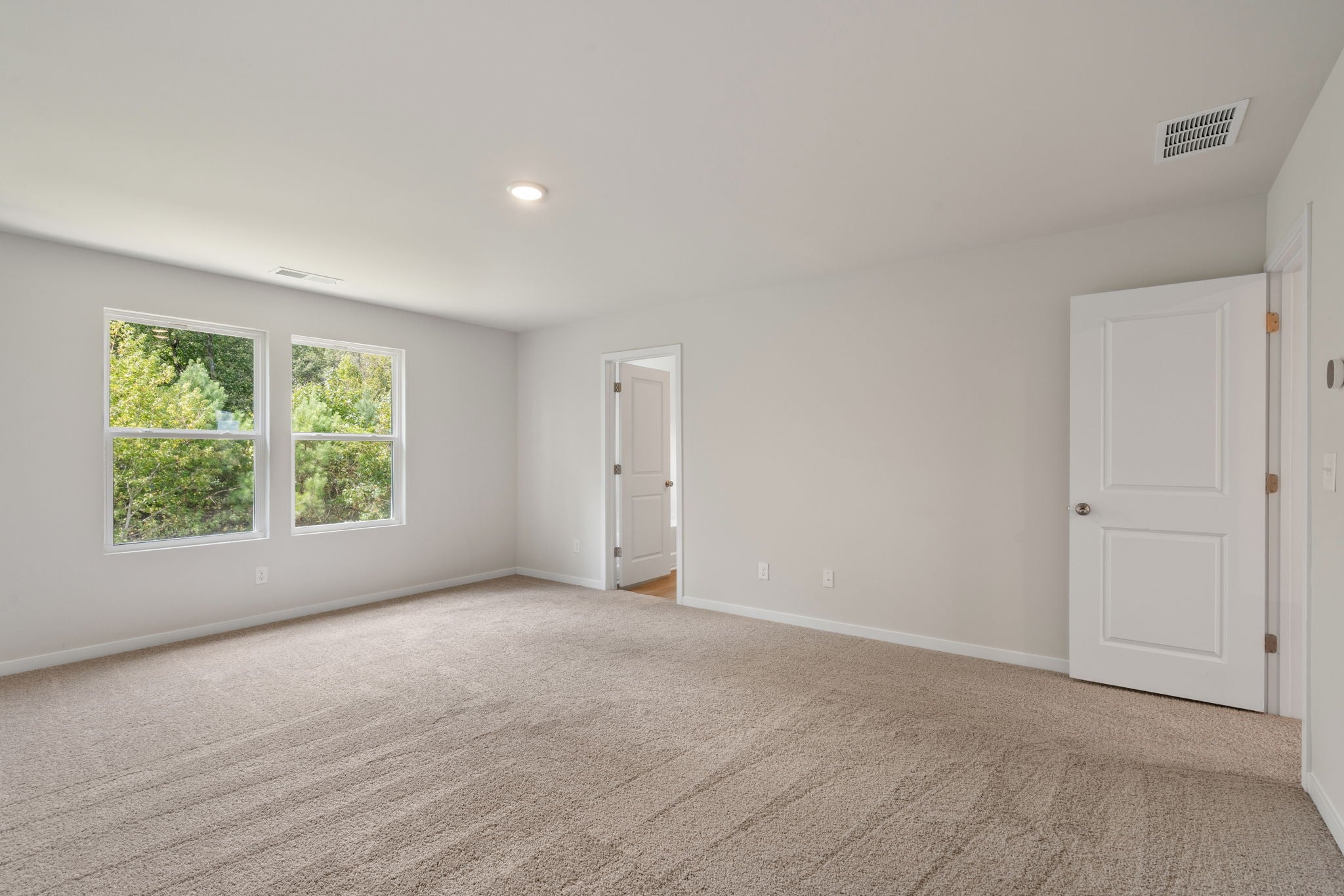 A room with white walls and windows.