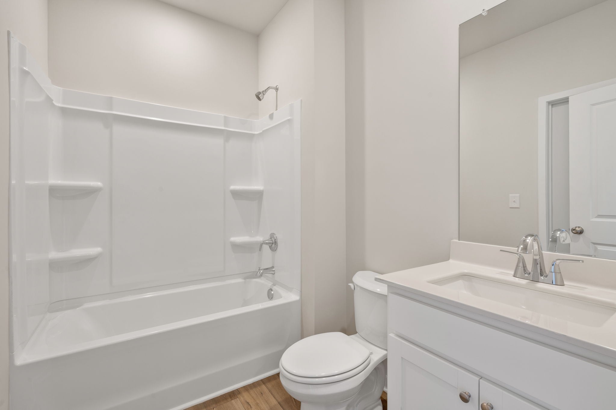 A bathroom with a tub toilet and sink.