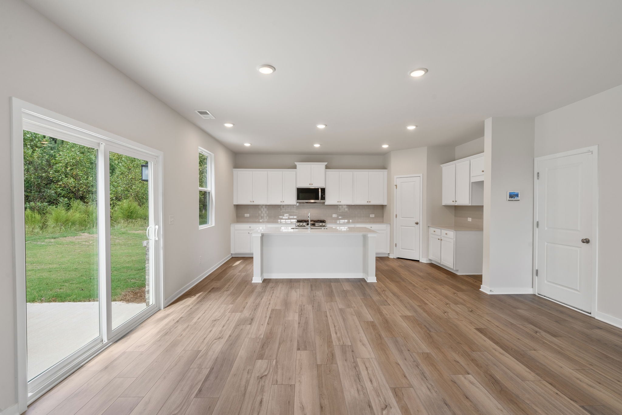 A kitchen with white cabinets.