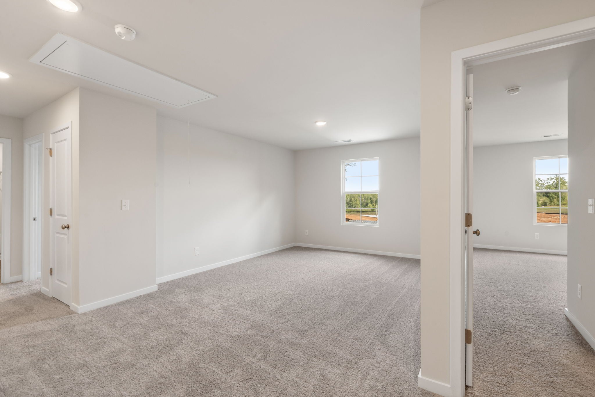 A room with white walls and a window.