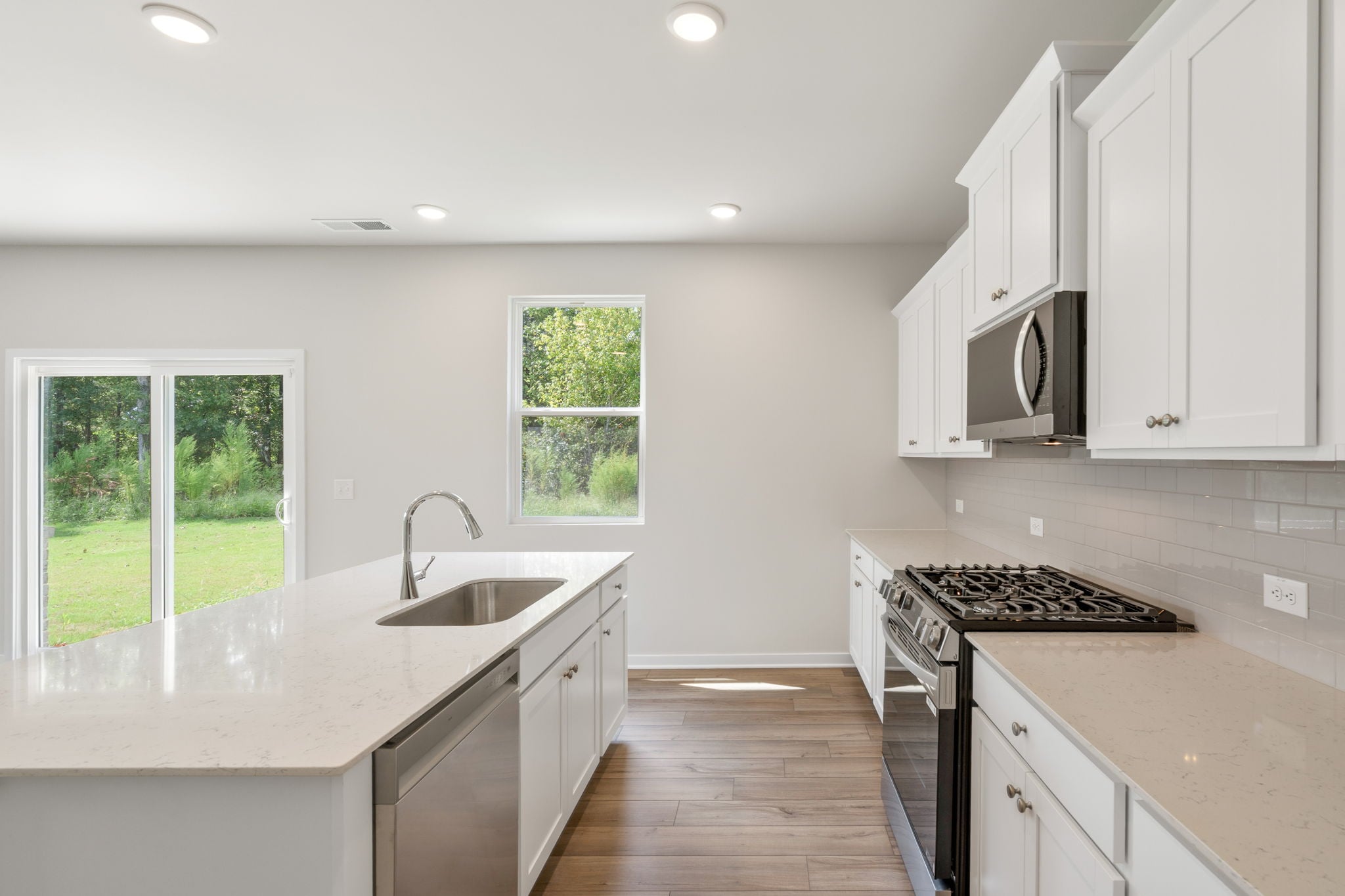 A kitchen with white cabinets.