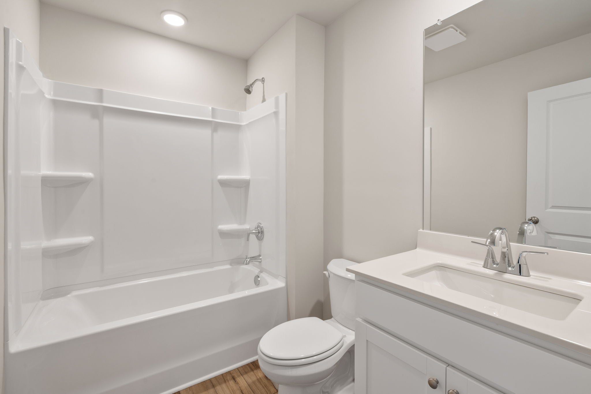 A bathroom with a tub toilet and sink.