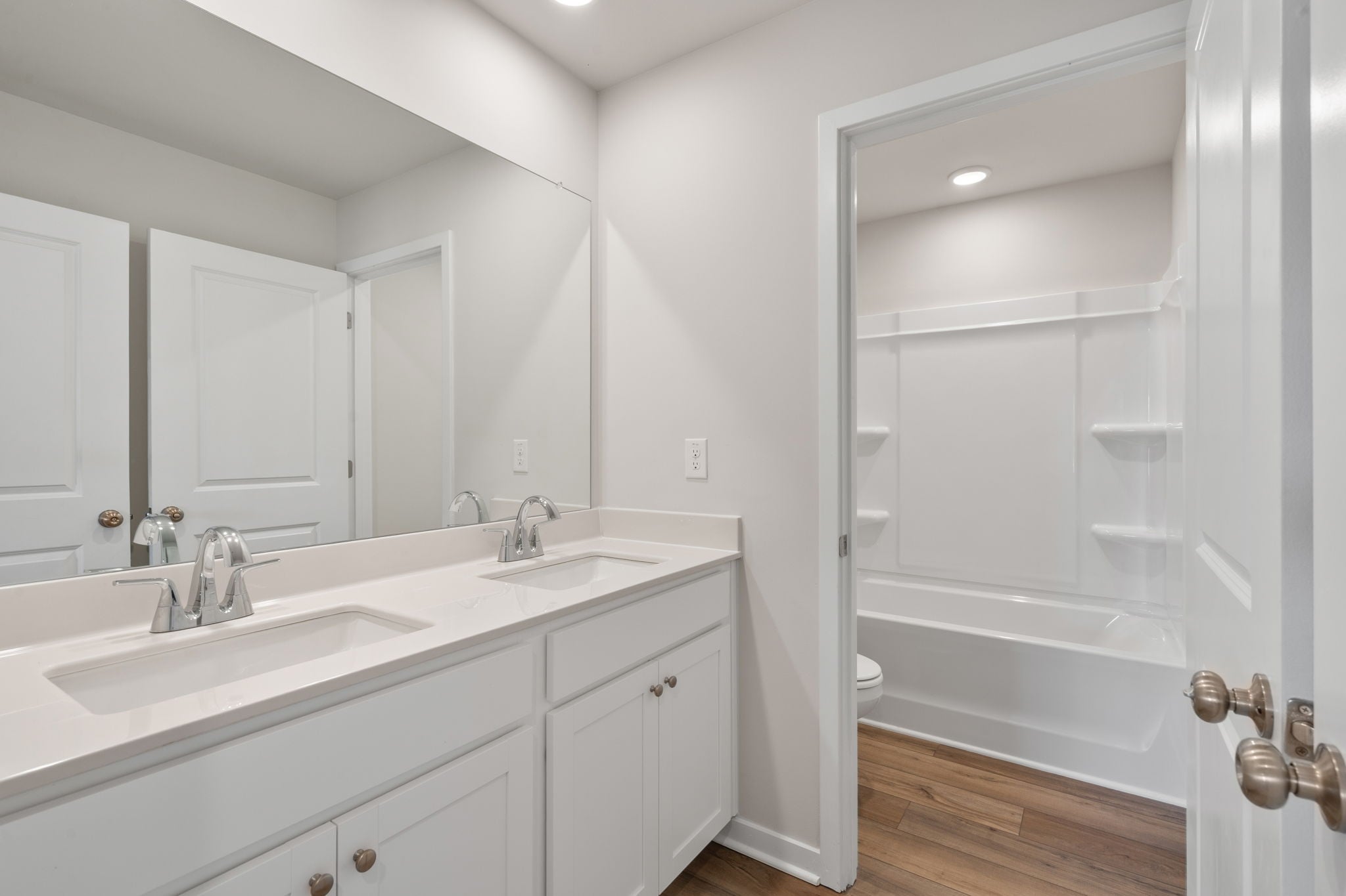 A bathroom with a tub sink and a shower.