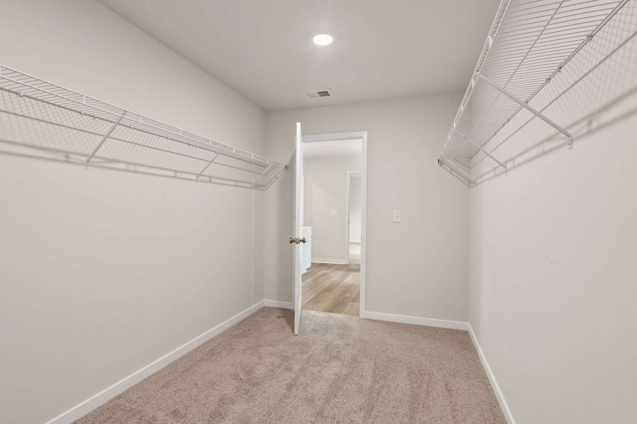 A hallway with white walls.