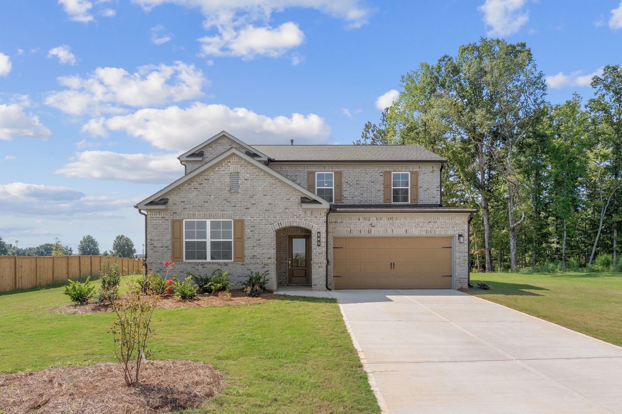 A house with a driveway and grass.