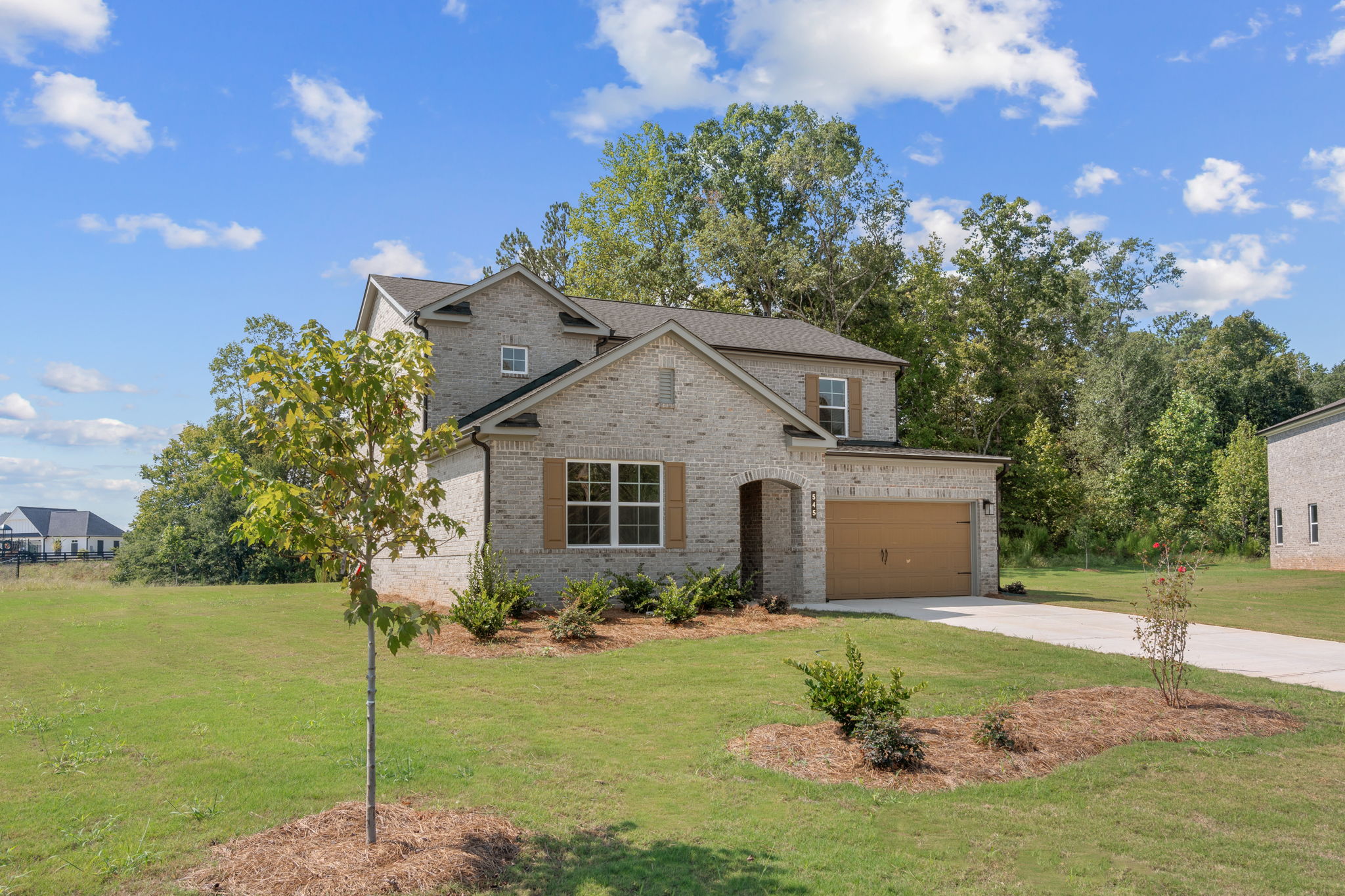 A house with a garage and trees.
