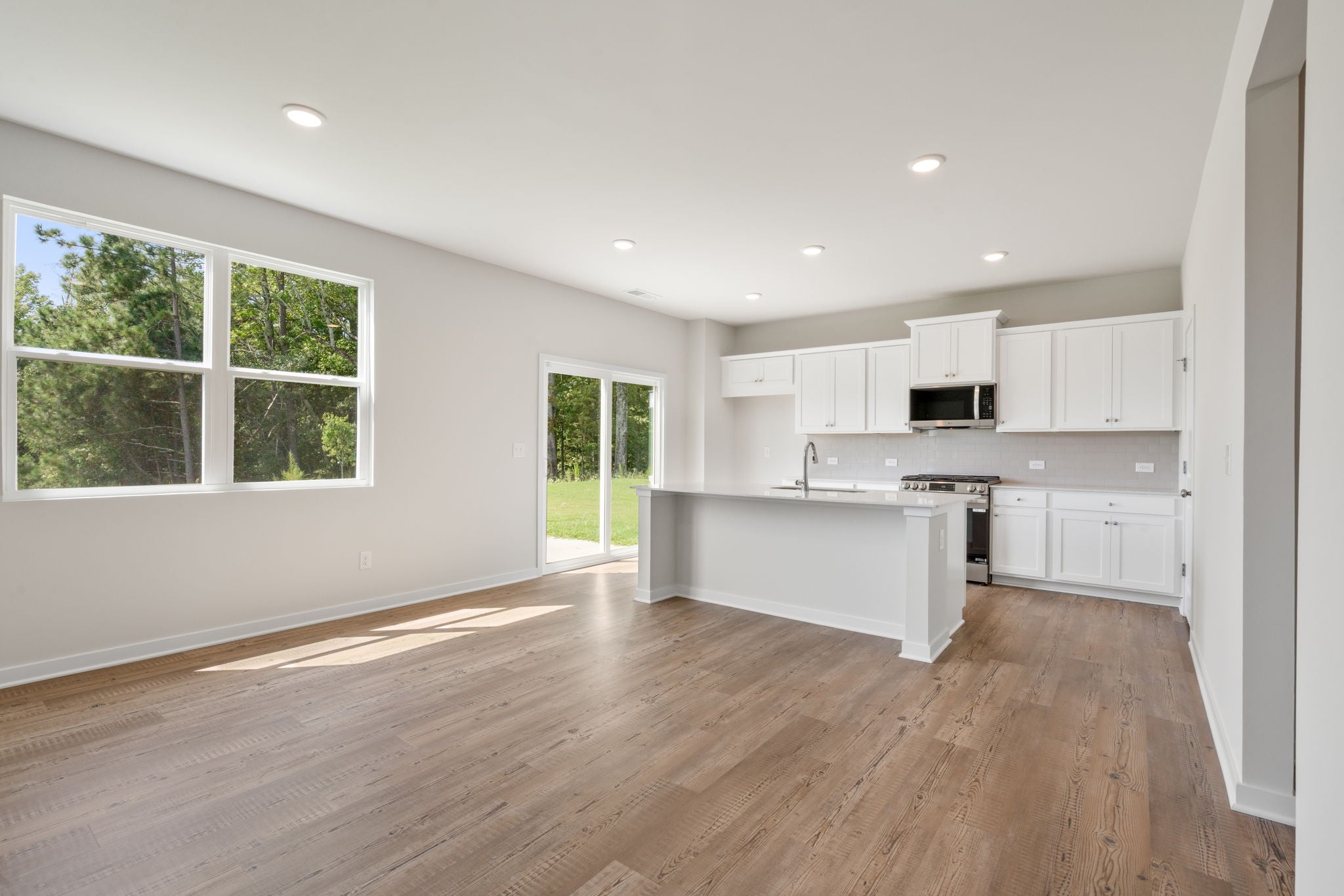 A kitchen with white cabinets.