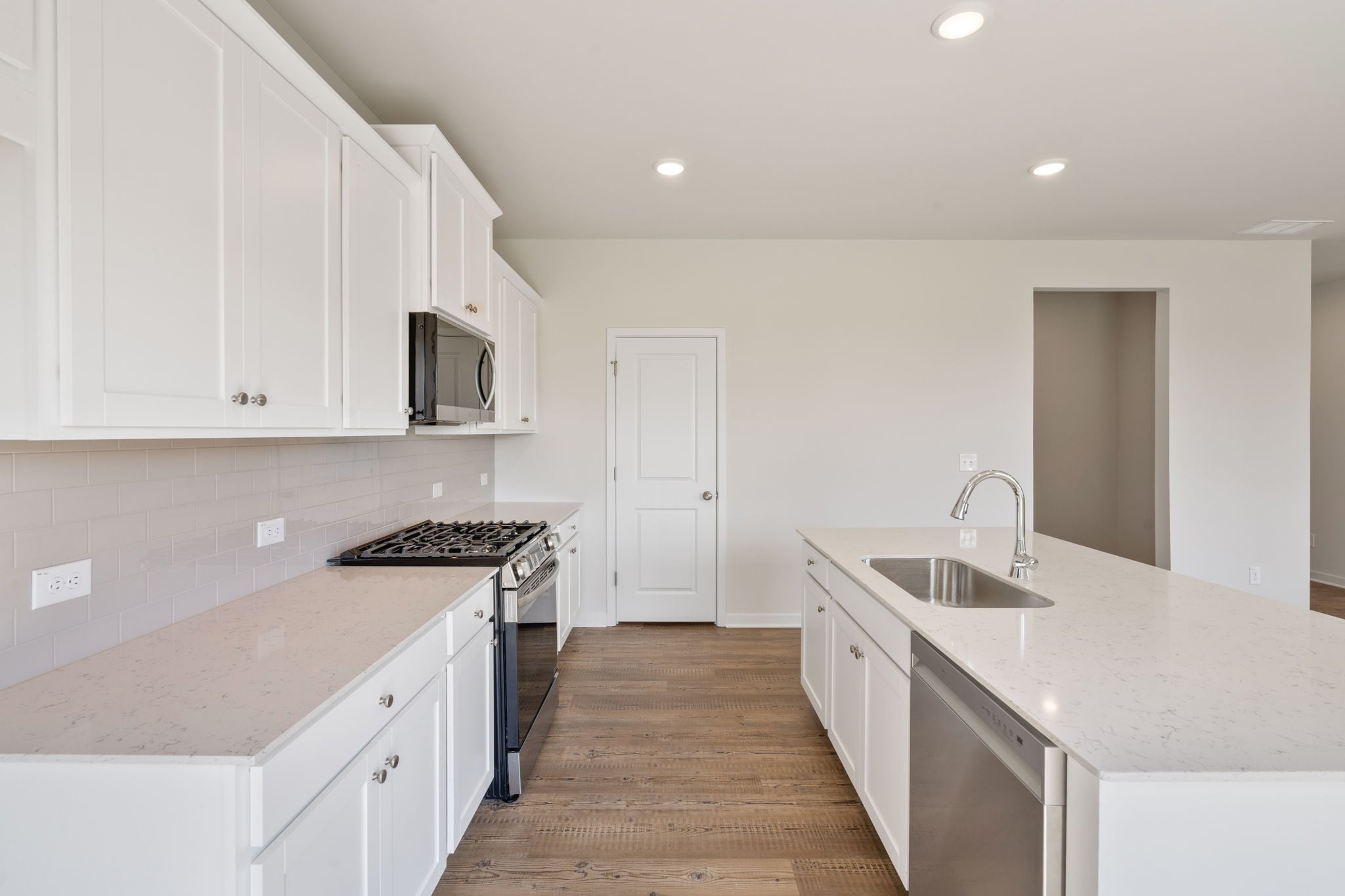 A kitchen with white cabinets.