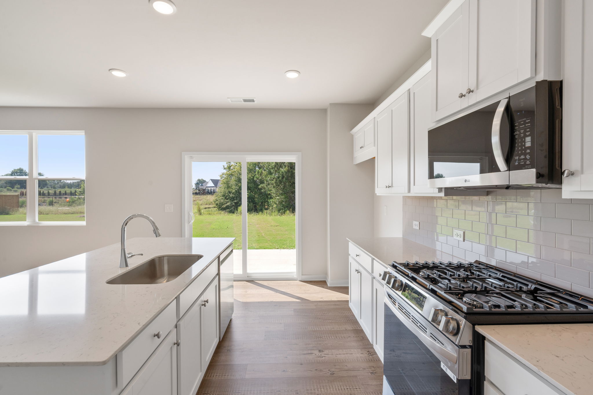 A kitchen with white cabinets.
