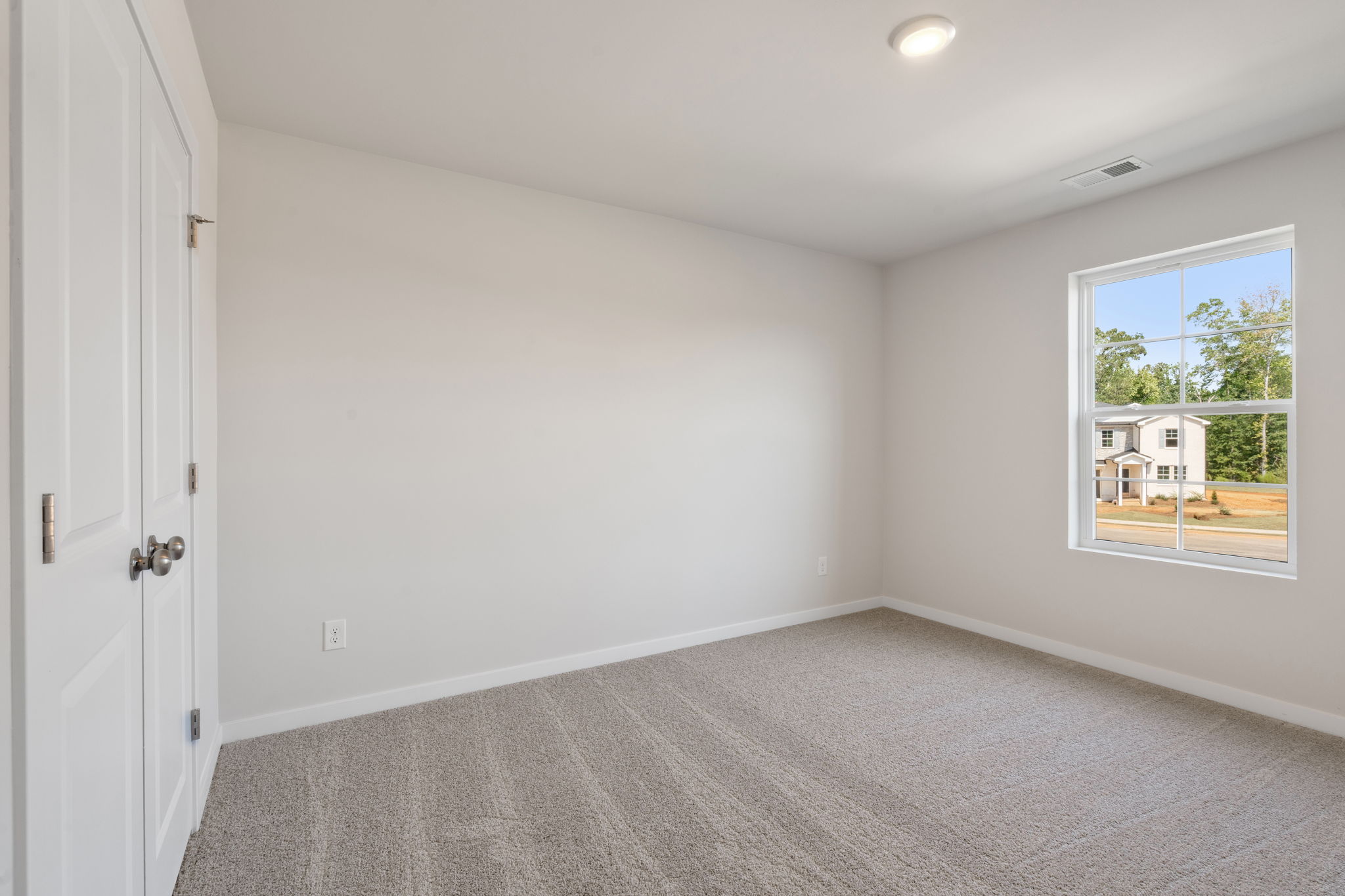 A room with a window and a door.