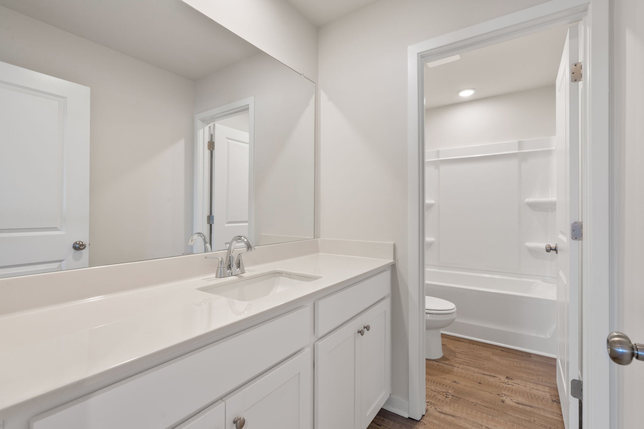A bathroom with a sink toilet and shower.