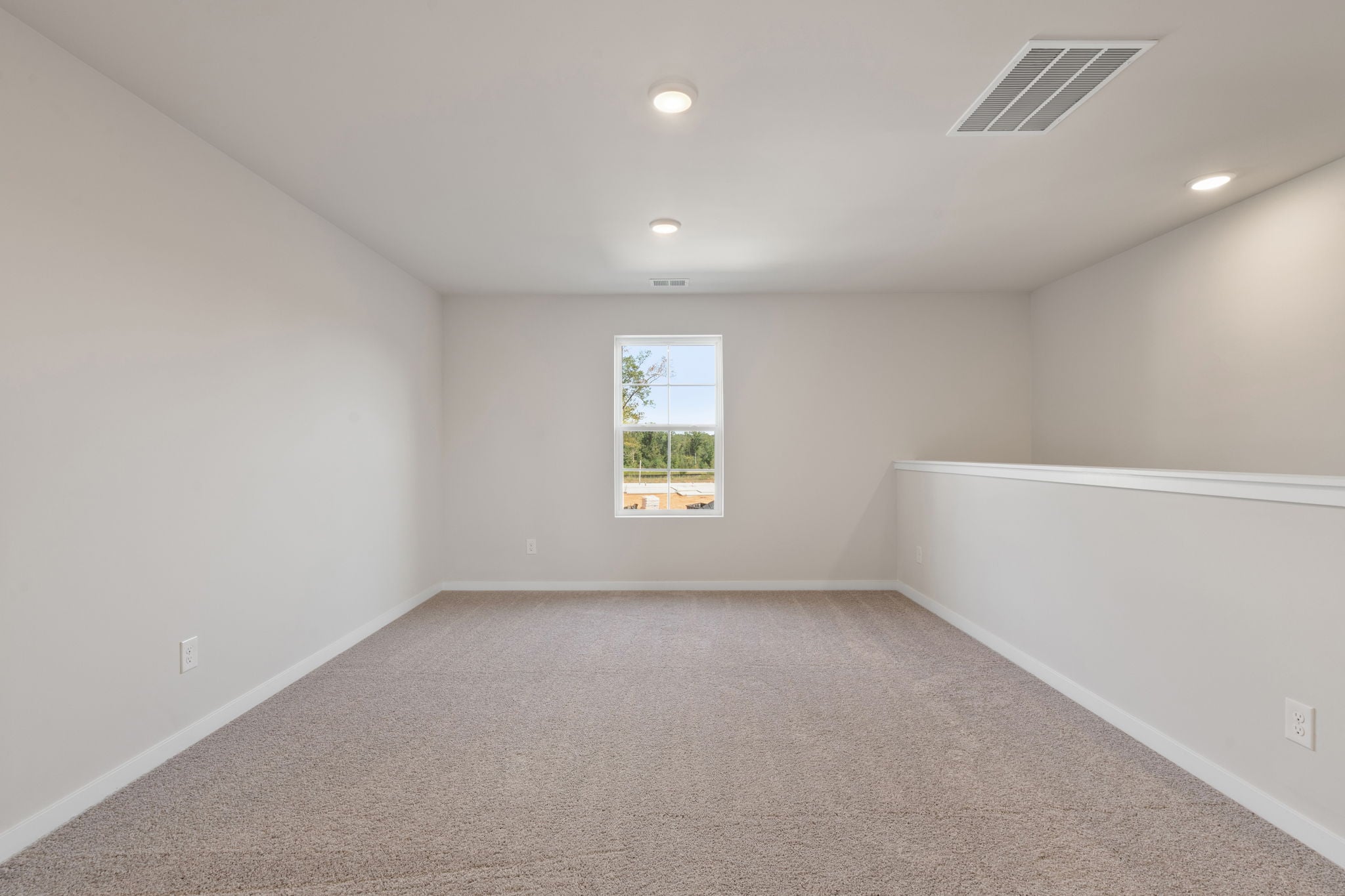 A room with a window and a carpet.