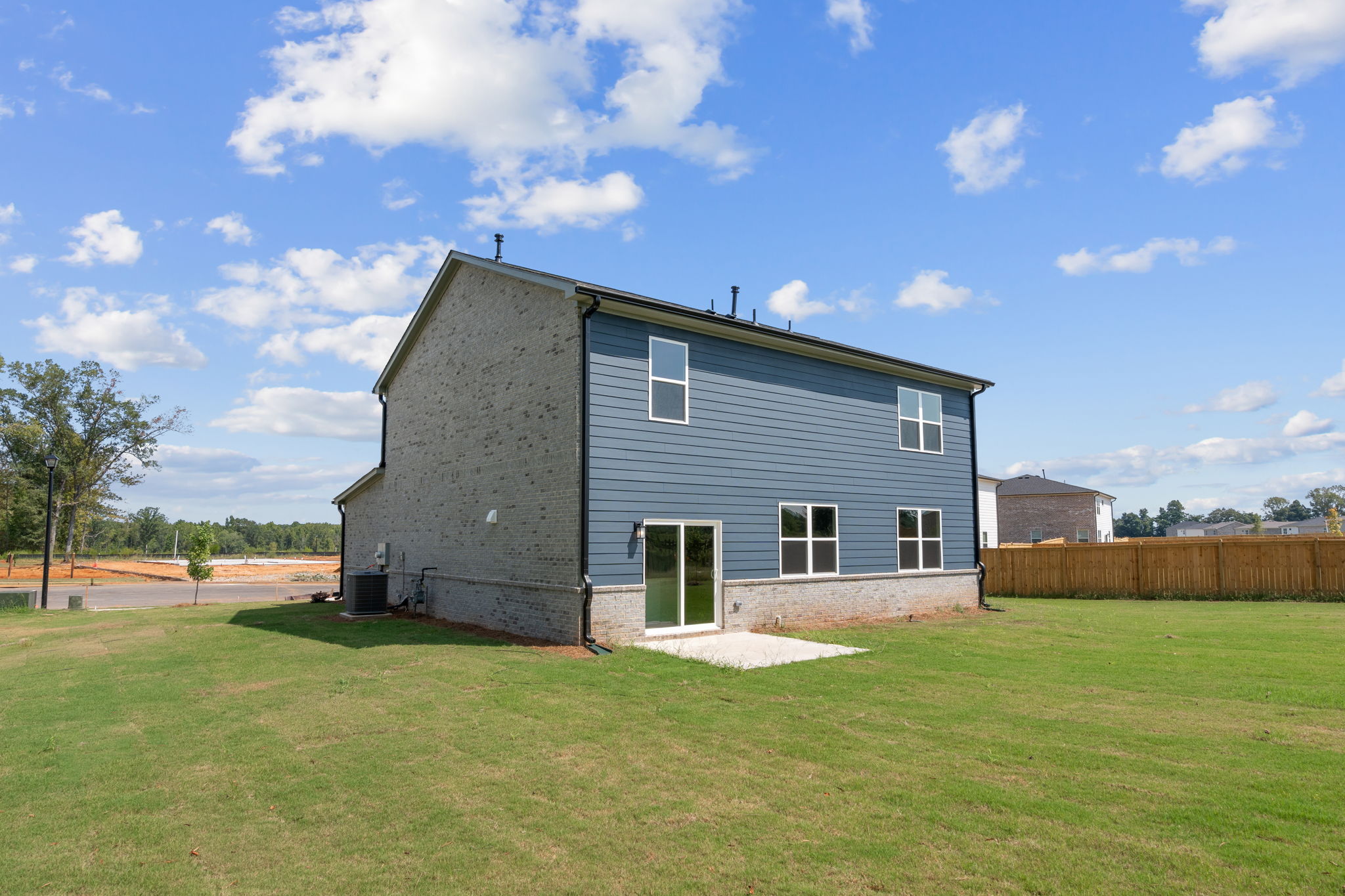 A house with a fence and grass.