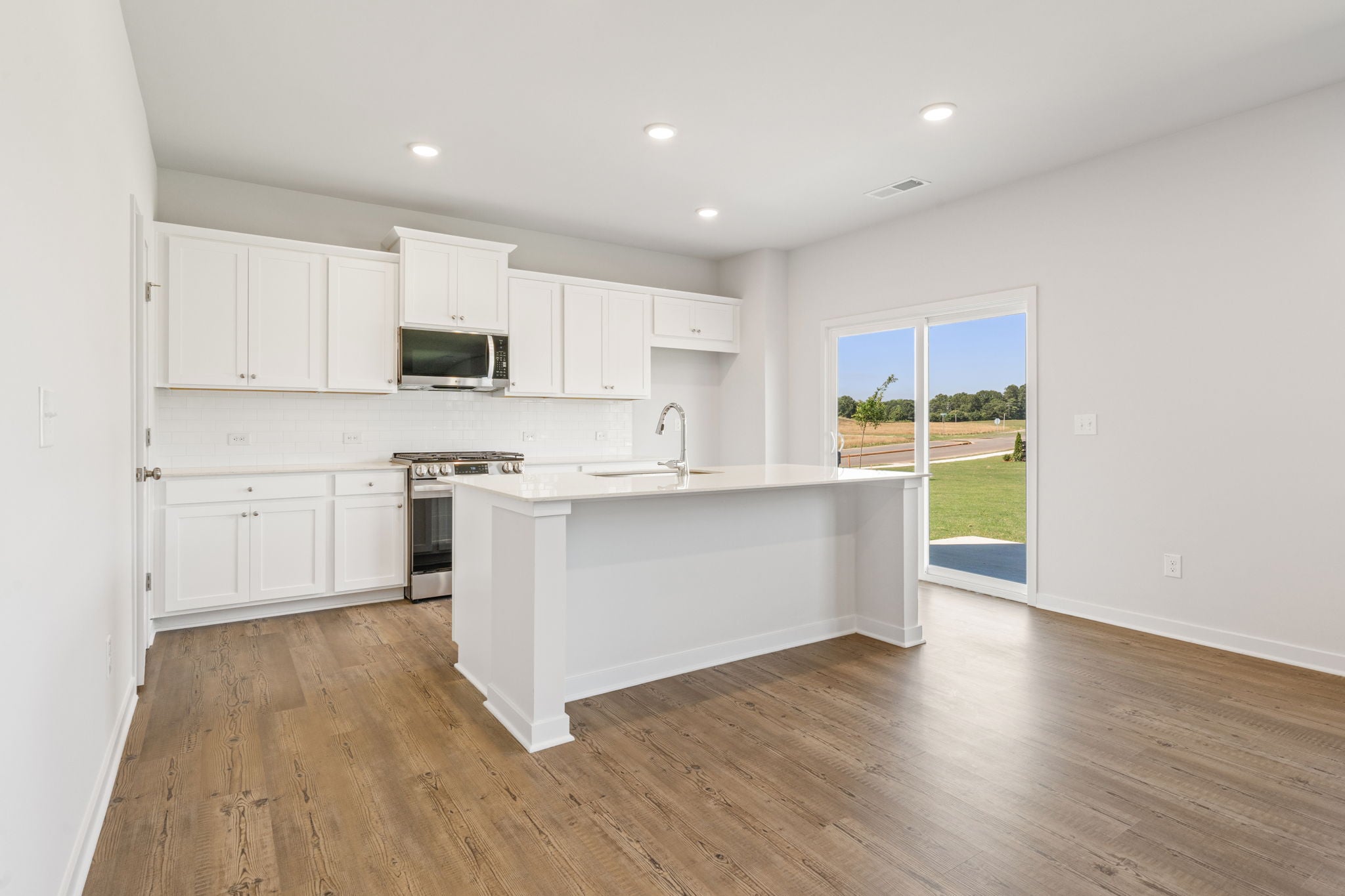 A kitchen with white cabinets.