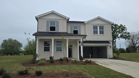 A white house with a driveway.