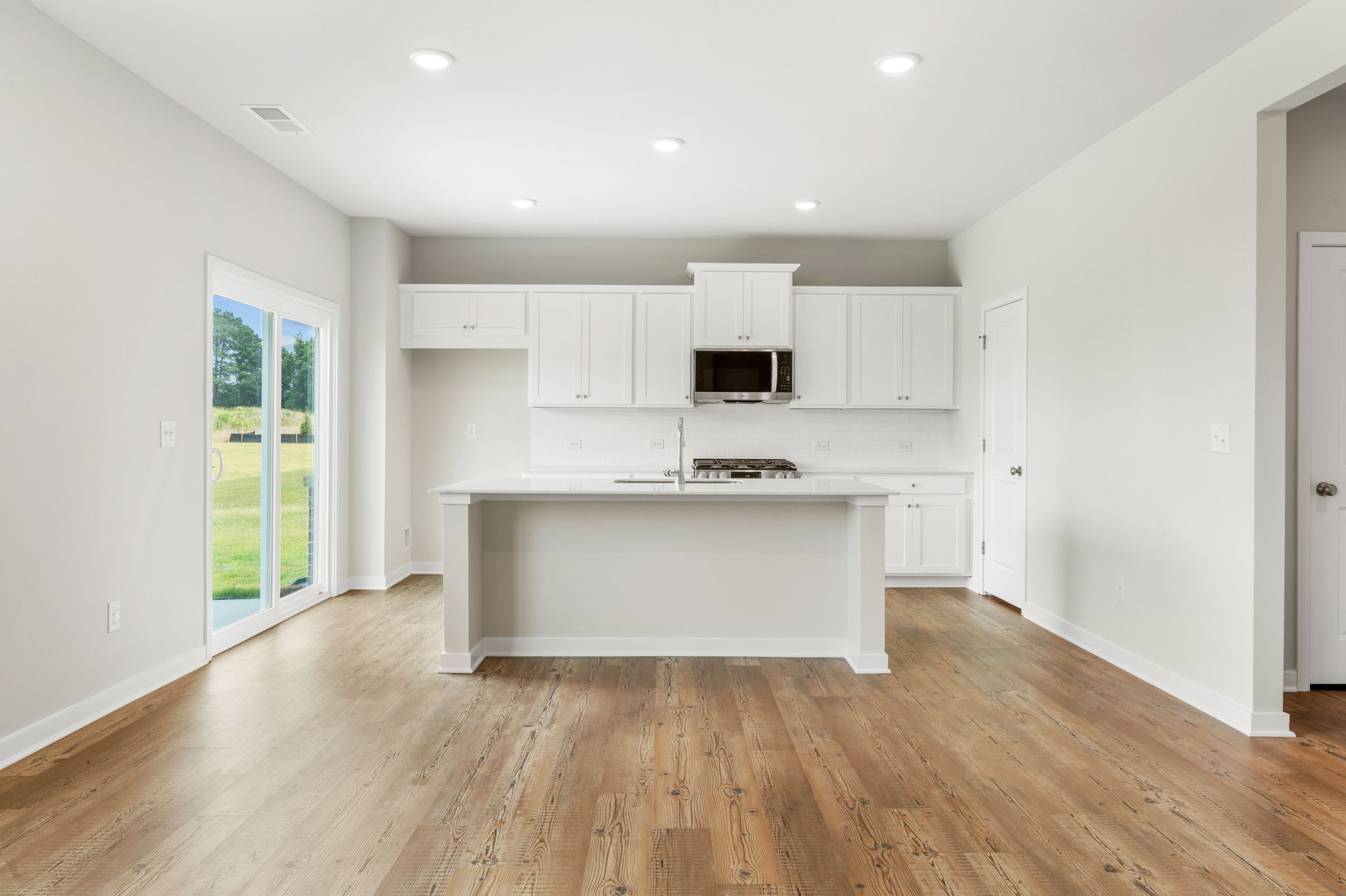 A kitchen with white cabinets.