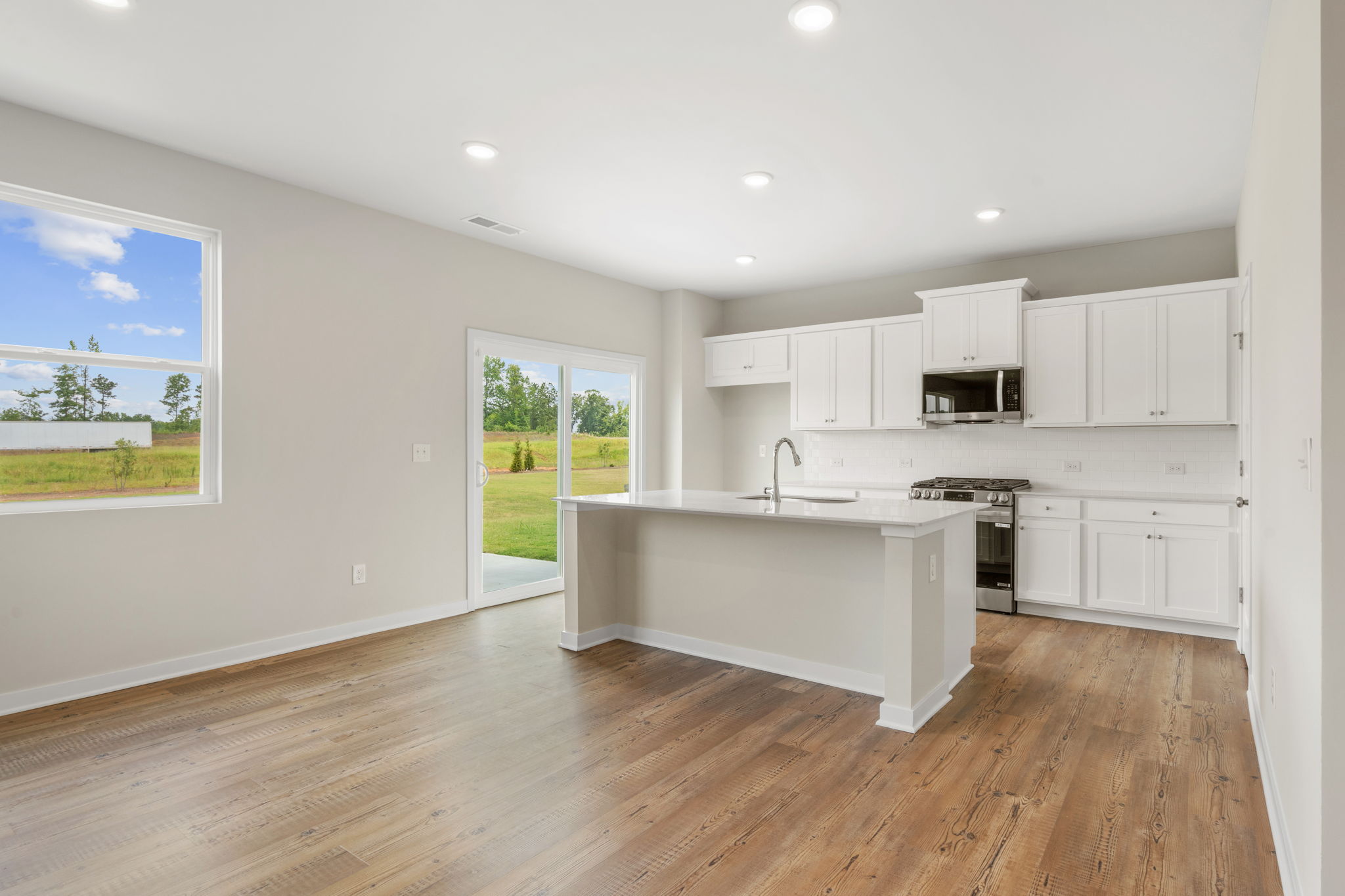 A kitchen with white cabinets.