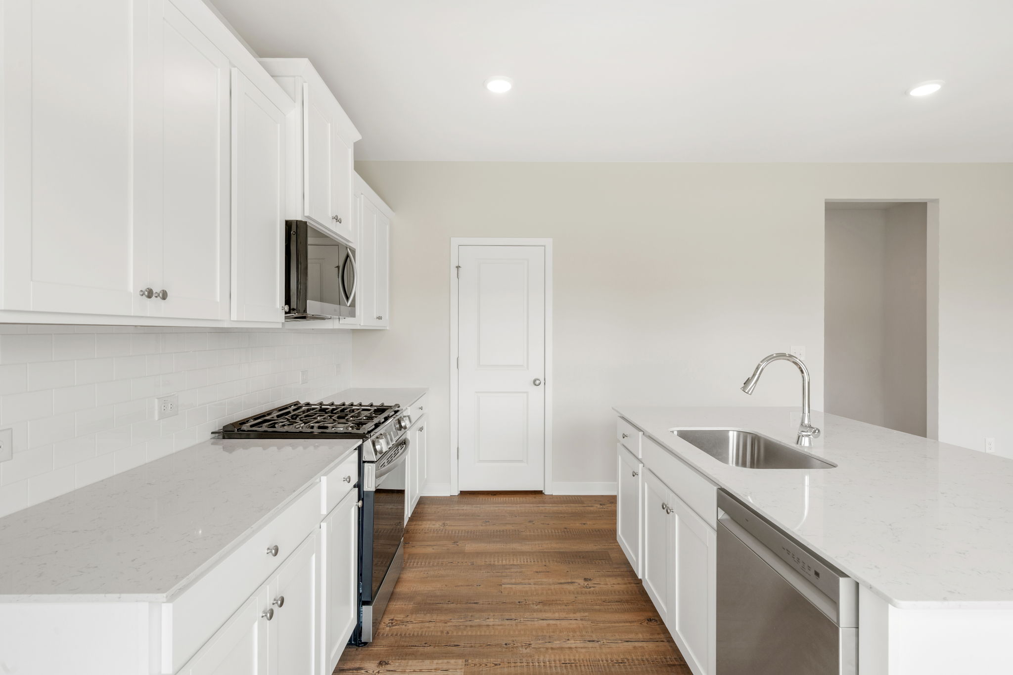 A kitchen with white cabinets.