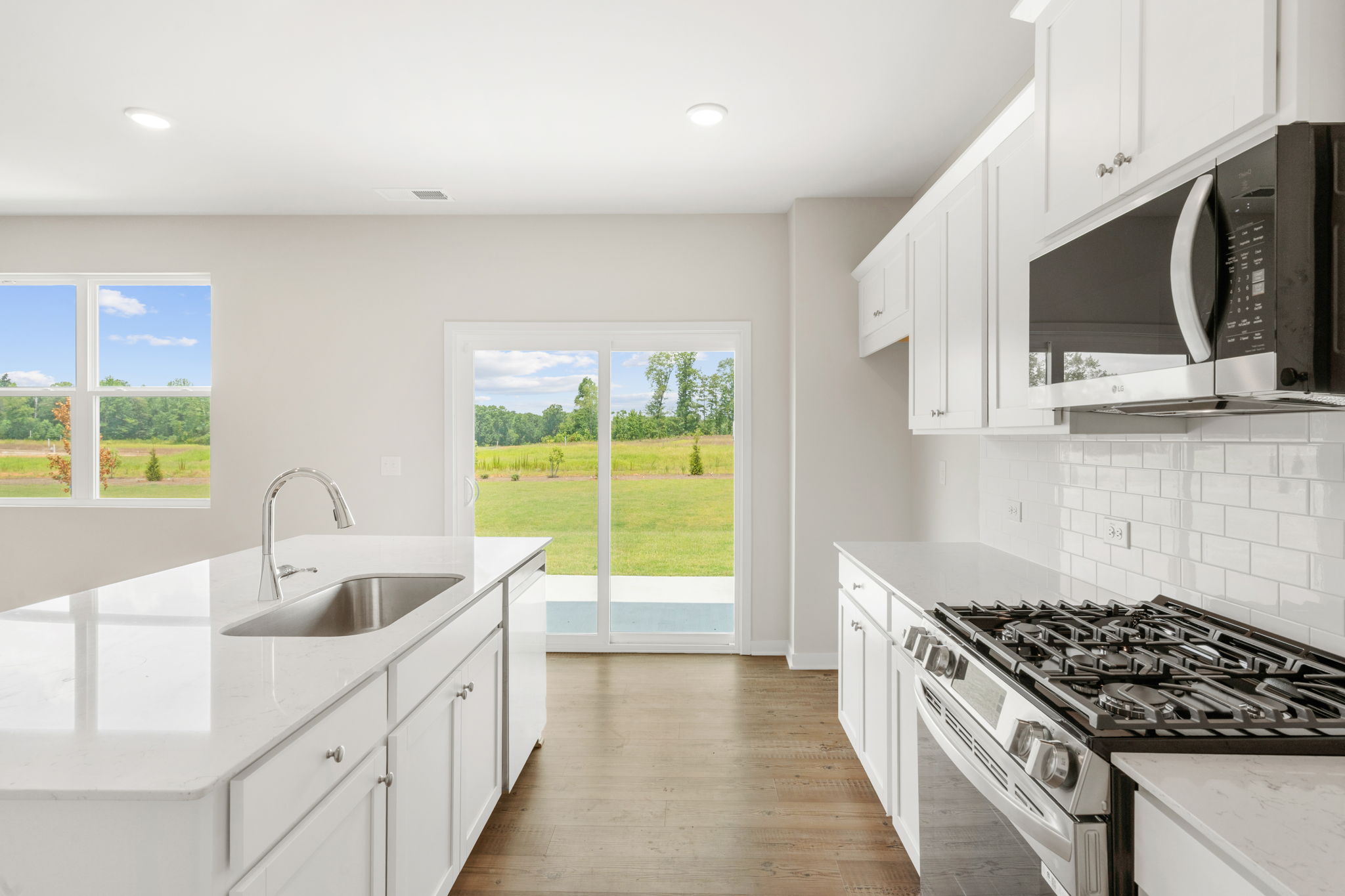 A kitchen with white cabinets.