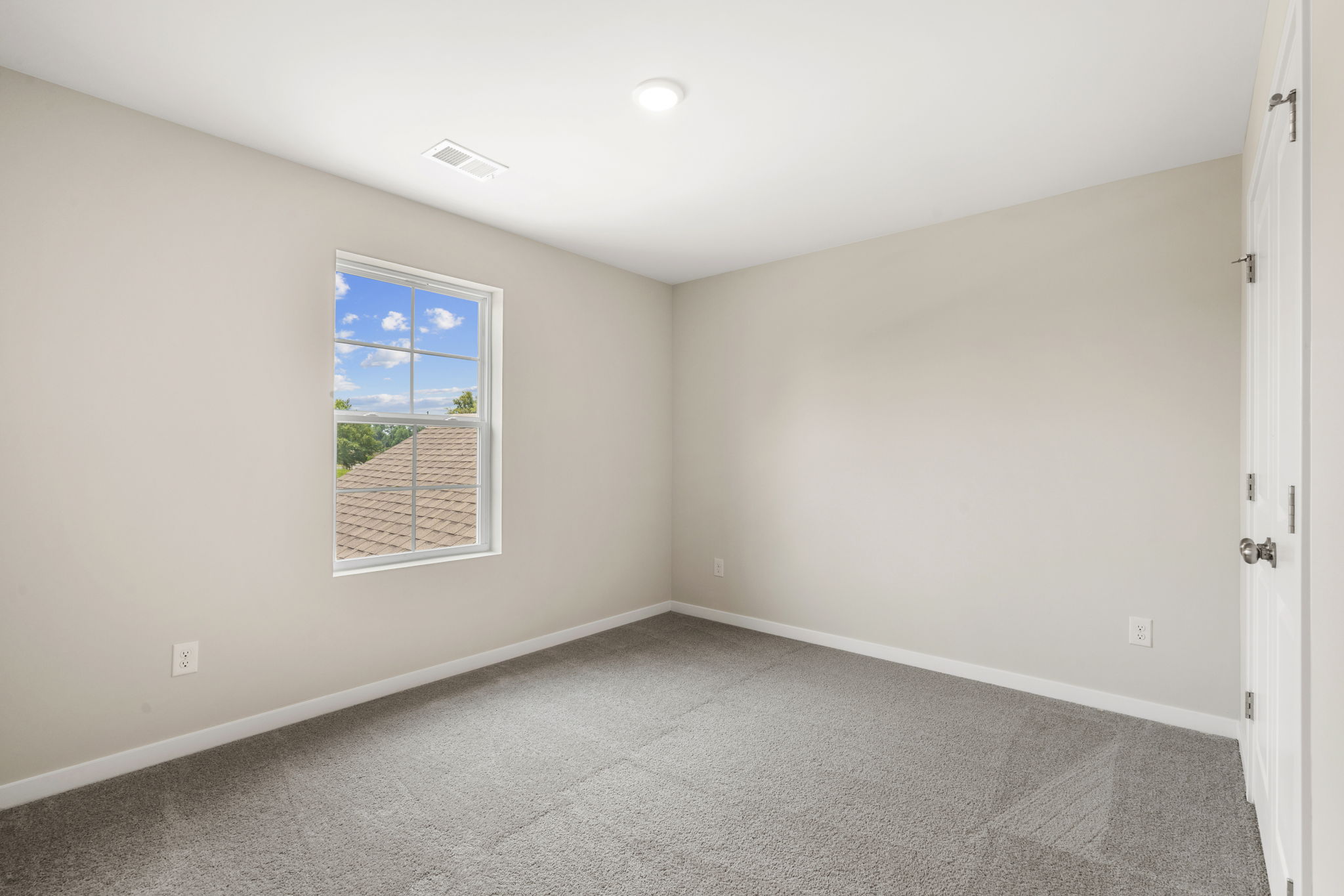 A room with a window and a door.