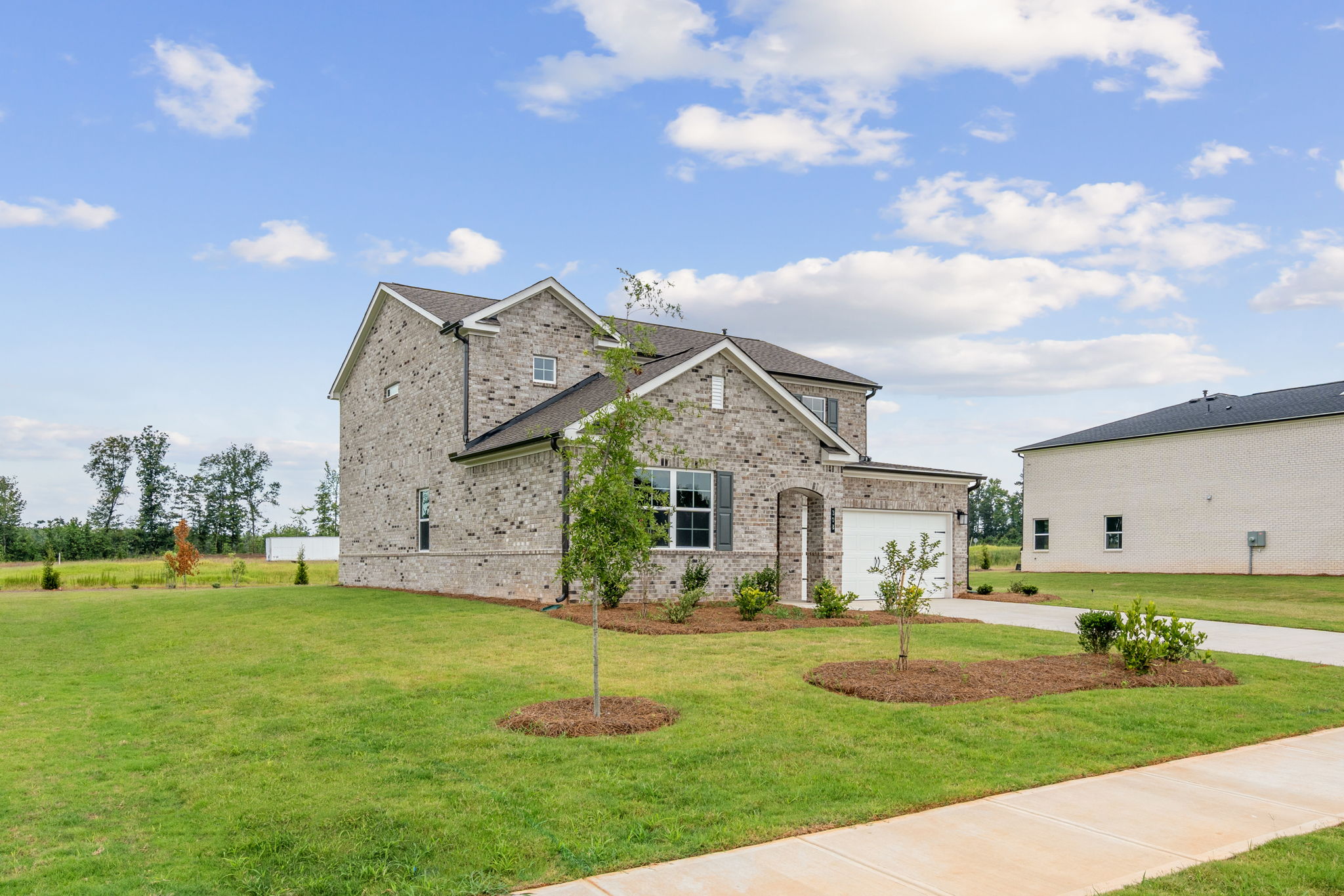 A stone house with a large yard.