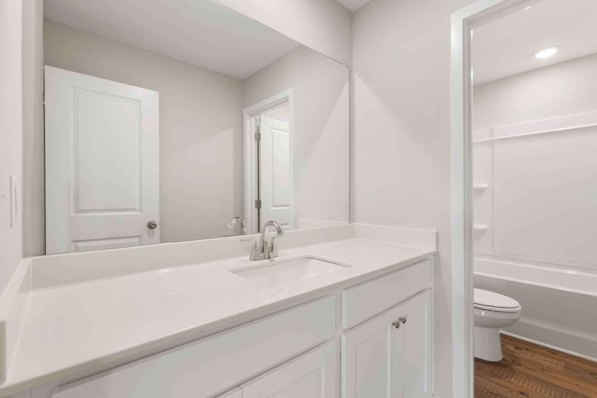 A bathroom with a sink toilet and shower.