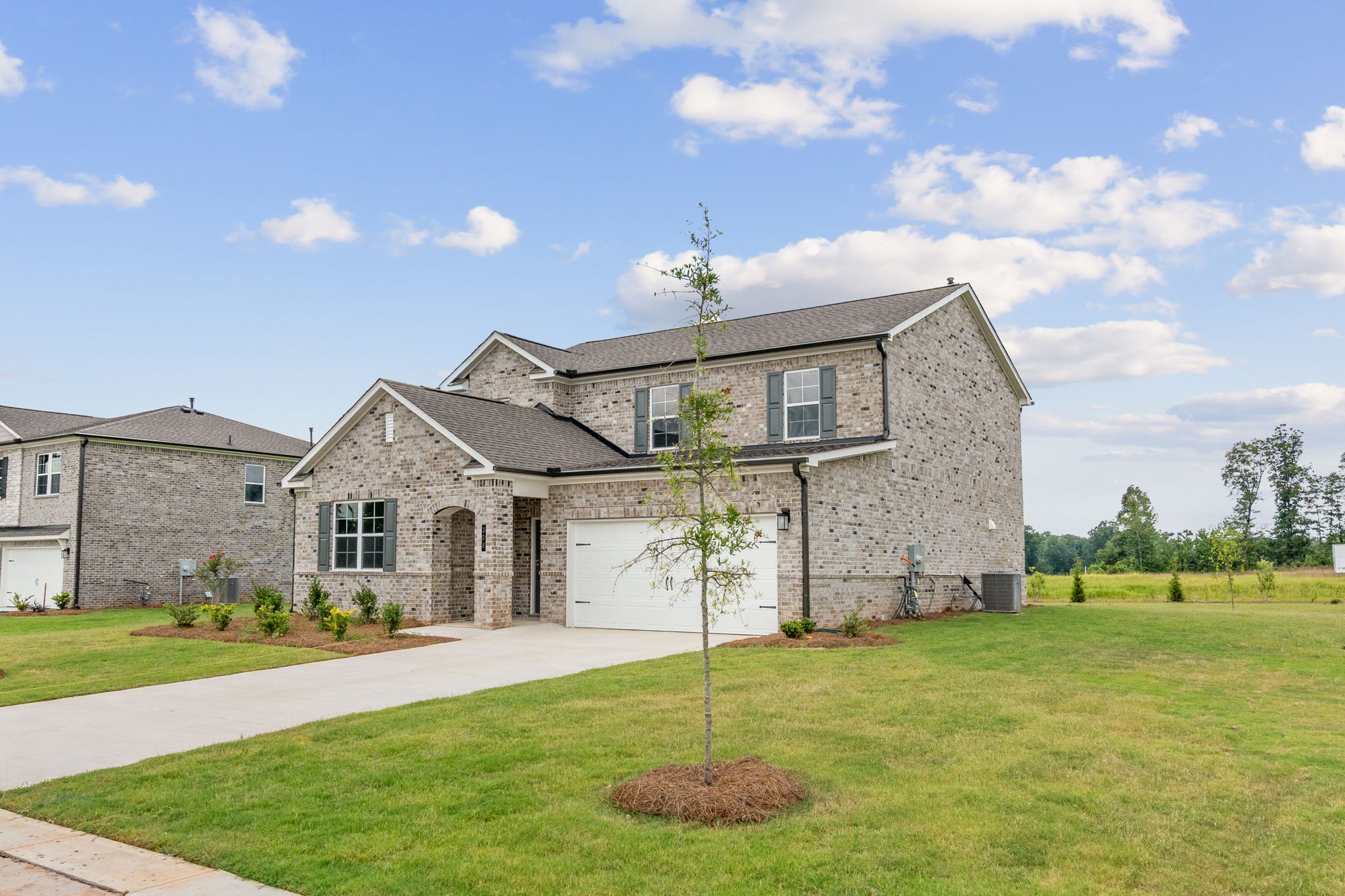 A large house with a large front yard.